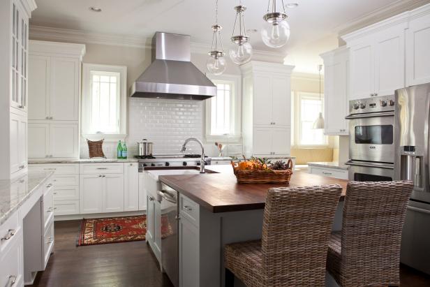 White Kitchen With Stainless Steel Range Hood & Subway Tile Backsplash