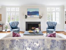 This formal living room was separated into two distinct spaces: one a bit more formal for entertaining, and the other providing a more casual atmosphere for relaxing. To maximize the budget, many of the homeowners' existing pieces were repurposed in the space.