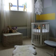 Contemporary Nursery in Gray With Oval Crib
