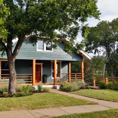 Blue Farmhouse With Natural Wood Fencing