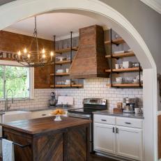 Arched Door Frame Leading from Living Room to Rustic Kitchen