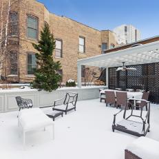Snow Covered Chicago Rooftop Patio With Brown Wicker Furniture 