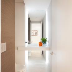 Modern Powder Room Features Corian Shelf With Sleek Built-in Sink