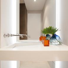 White Modern Powder Room Features Sleek Architectural Sink With Linear Drain