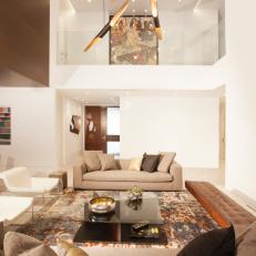 Chic Living Room Features Eye-Catching Pendant Lights Over Sofa, Chair & Banquette Seating