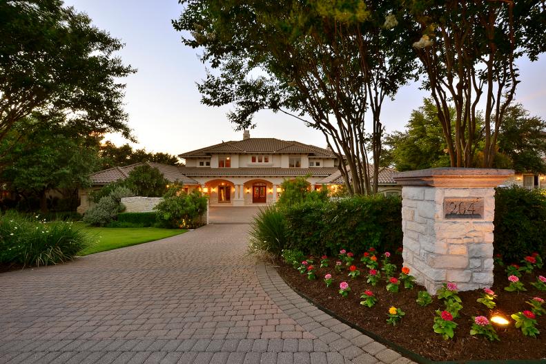 Paver Driveway Leading to Neutral Mediterranean-Style Home
