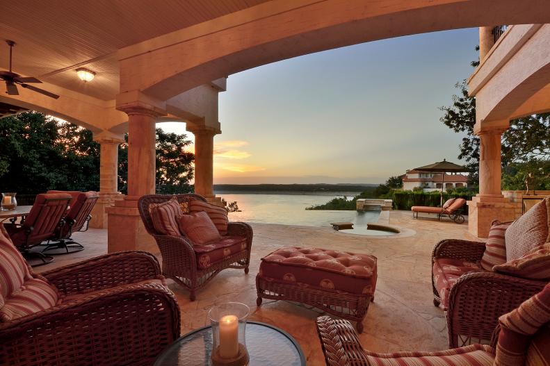 Mediterranean Covered Patio With Cushioned Seating and Lake View