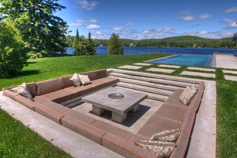 Sunken Outdoor Seating Area With Modern Concrete Fire Pit in Center