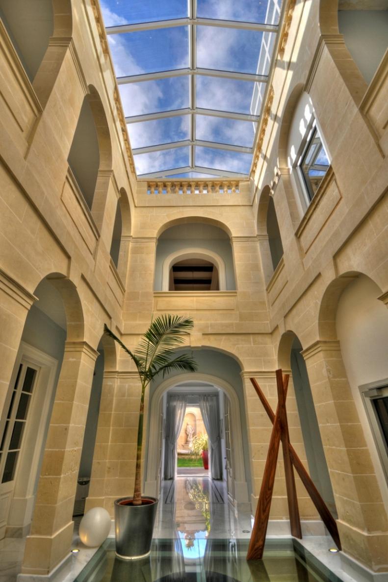 Traditional Hallway With Stone Archways, Skylights and Glass Floor