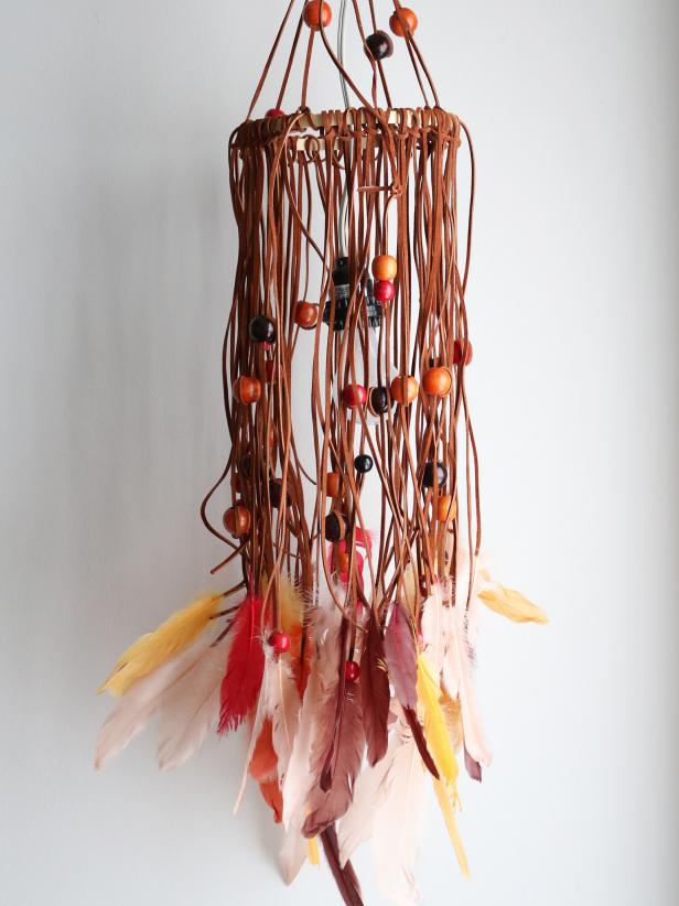 Your home will have that bohemian flair with this leather chandelier pendant light. Everyday art supplies are transformed into a feathered and beaded conversation piece to accent your favorite room.