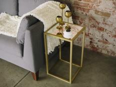 Make a gold end table on a budget by using square wood dowels and gold spray paint.