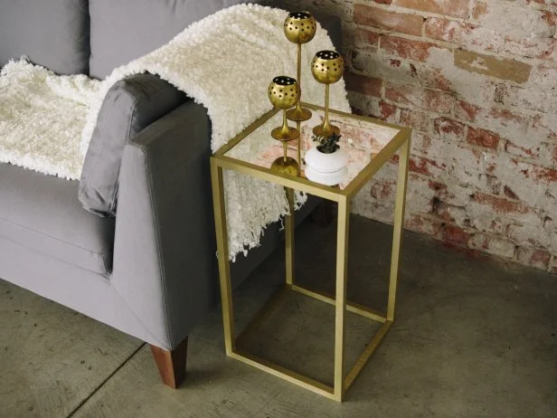 Make a gold metallic table on a budget using gold spray paint and square wood dowels.
