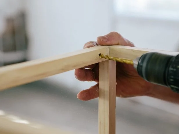 Drill holes in table base where the shelf pegs will go.