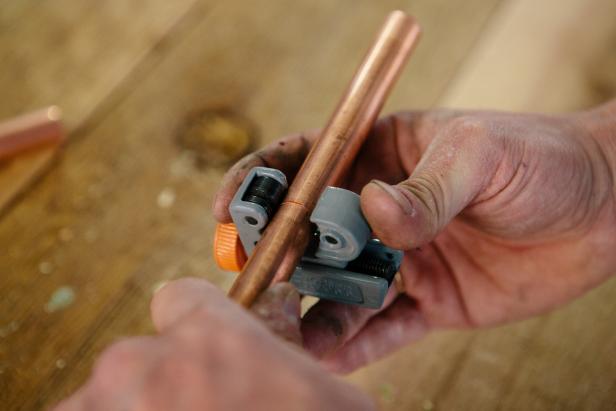 Cut copper piping at 2-3-inch lengths to make a one-of-a-kind candelabra.