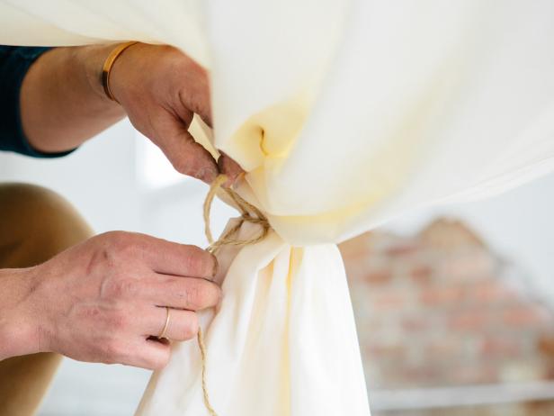 Tie the bunched fabric together using rope or twine, and cut off any excess fabric if desired.