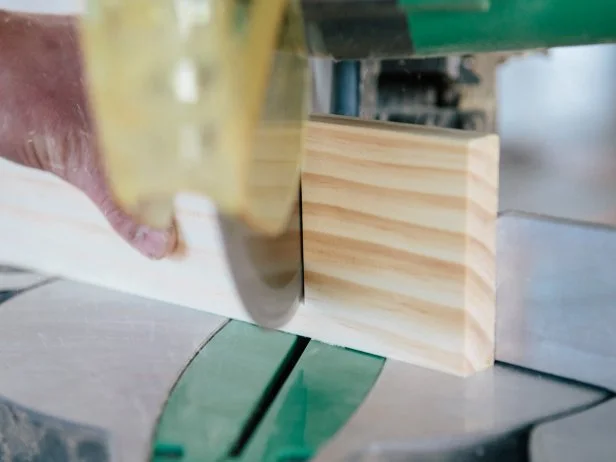 Cut wood piece at a 30-degree angle using a miter saw to make a triangle shelf.