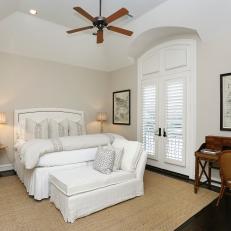 Traditional Bedroom With White Bed and Chaise Lounge