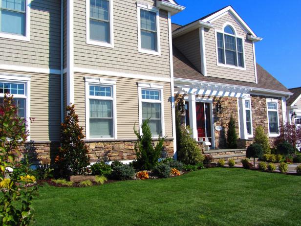 Exterior of Neutral Home With Shake Shingles, Stone Veneer & Pergola