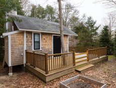 Wood Shingle Home With Deck and Evergreen Trees