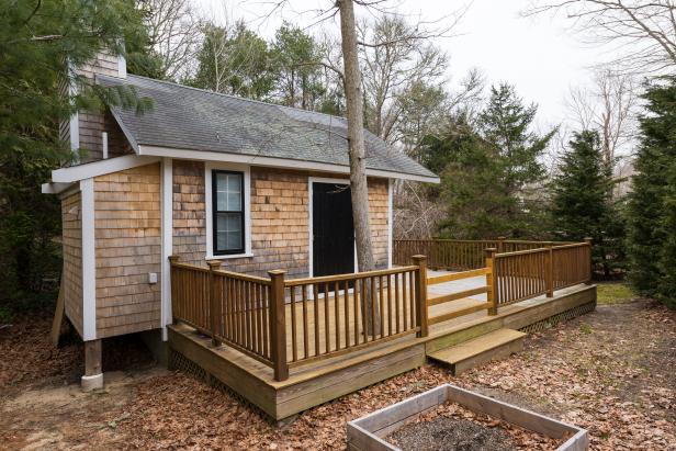 Wood Shingle Home With Deck and Evergreen Trees