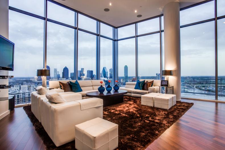 Modern Living Room With Large Windows, White Furniture & Brown Rug