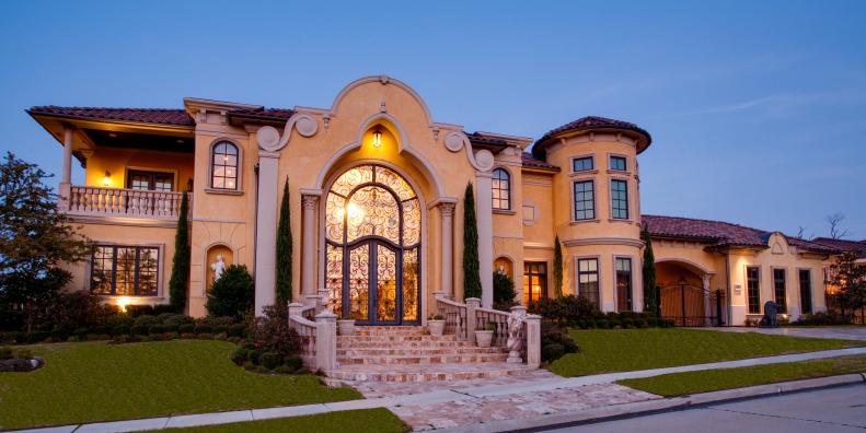 Exterior of Large Yellow Mediterranean-Style Home With Grand Entry