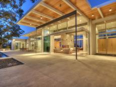 Indoor-Outdoor Living Room and Concrete Patio With Glass Walls