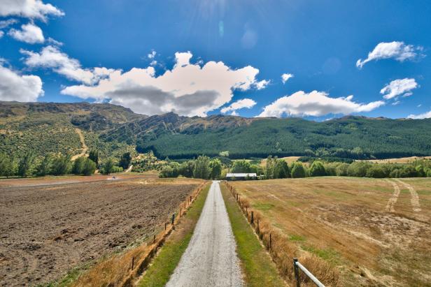 Gravel Road Leading to Countryside Home