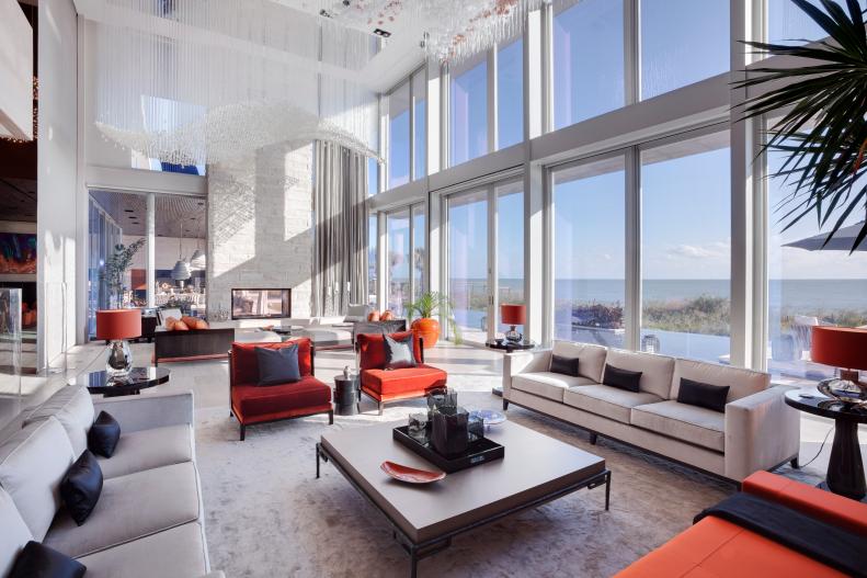Modern Living Room With Red Chairs, Neutral Sofas & Ocean Views