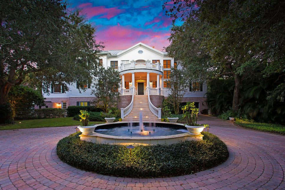 Picturesque Sunset Over Sarasota Home With Stone Driveway and Gorgeous Stairwell 