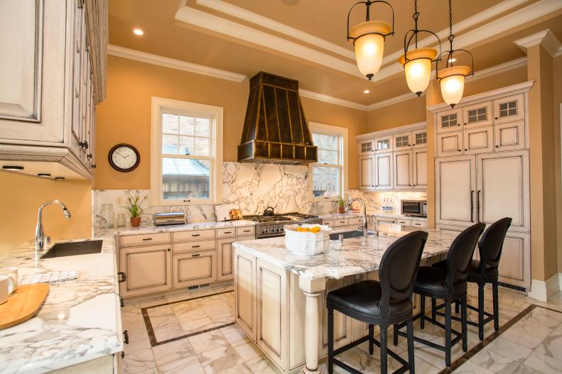 Golden Tan Kitchen With White Cabinets, Marble Floor & Marble Counters