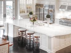 Large White Island With White Marble Countertop in White Kitchen