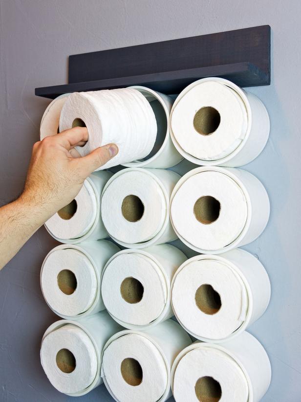 Place the top row of the couplings over the two screws to hang. Fill the couplings with toilet paper or other bathroom accessories, and merchandise the top shelf as desired.