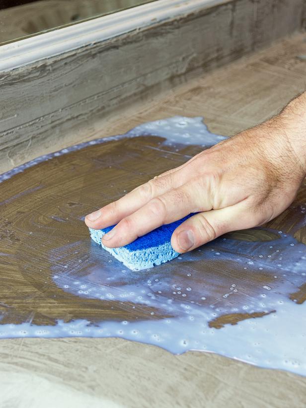 Liberally apply concrete sealer to the entire surface with a sponge.  Apply three coats allowing the sealer to dry between each coat.