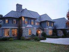 Gray Stone and Stucco French Normandy-Style Home With Yard