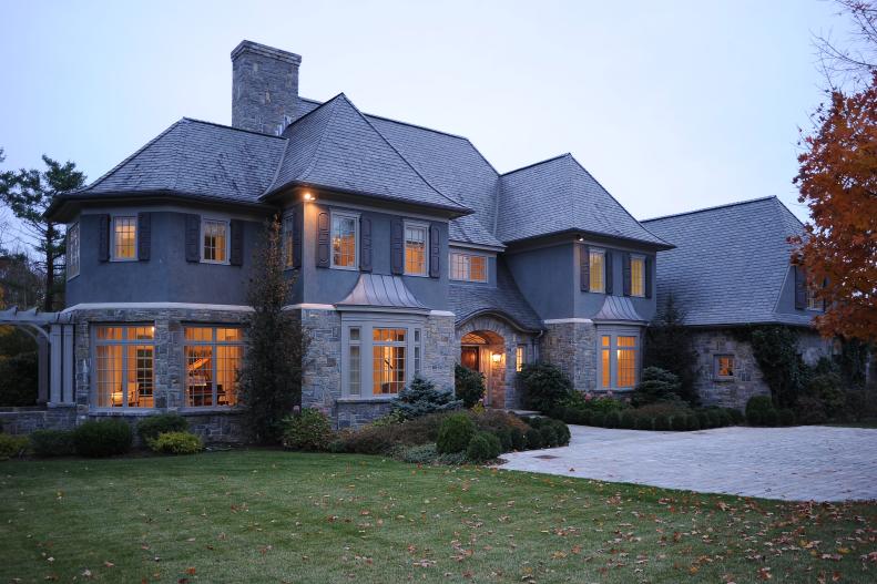 Gray Stone and Stucco French Normandy-Style Home With Yard