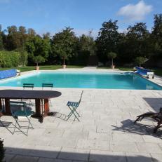 Stone Tile Pool Deck Surrounds Square Swimming Pool at Puerto Dreux Home 