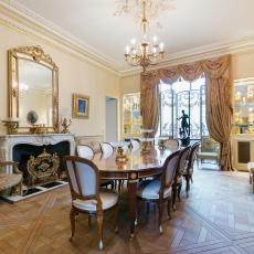 Decorative Victorian Dining Room in Paris With Long Wood Table and Gold Details 