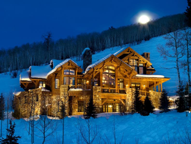This Edwards, Colorado home in Arrowhead's slopes features ski-in/ski-out access and includes mountain views from almost every room within the house. The exterior relies on a combination of neutral stone and wood materials to create a rustic finish, while the rear of the home features a private hot tub area.