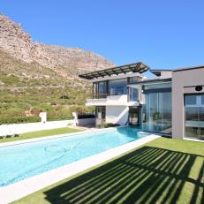 Modern Glass Stonehurst Home With Long Swimming Pool and Short Grass Yard 
