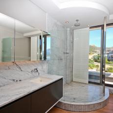 Sleek Modern Bathroom With Large Glass Enclosed Shower and Gray Marble Finishes 
