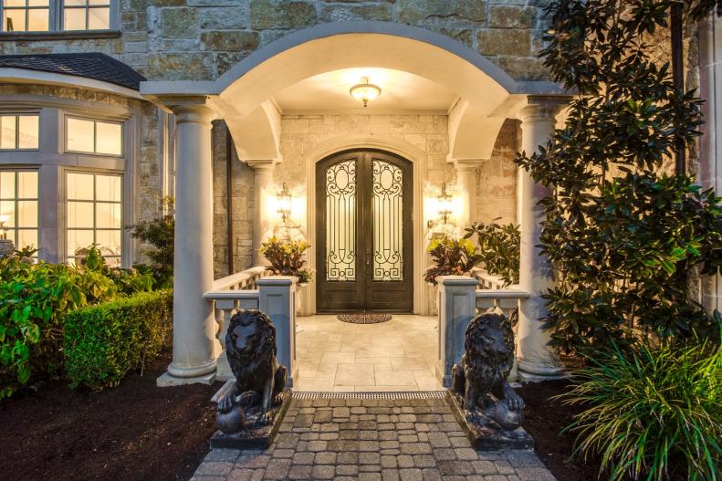 Entrance to Mediterranean-Style Home With Columns and Lion Statues