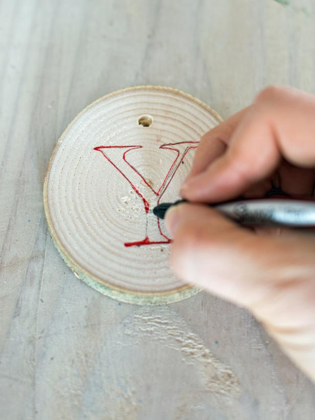 Using a fine-tipped permanent marker, color in the traced lines. Tie each wood slice on a piece of twine approximately 2-3&quot; in length. Then, tie each wood slice onto a piece of twine 3-4&quot; in length to make a banner. Tip: These can be used as ornaments and gift tags as well!