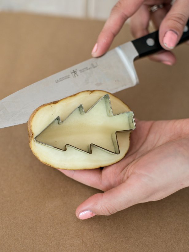 Cut around the cookie cutter at about 1/2&quot; depth, so part of the potato inside cookie cutter will protrude 1/2&quot;. Remove cut portion of the potato around cookie cutter. Remove cookie cutter from the potato.