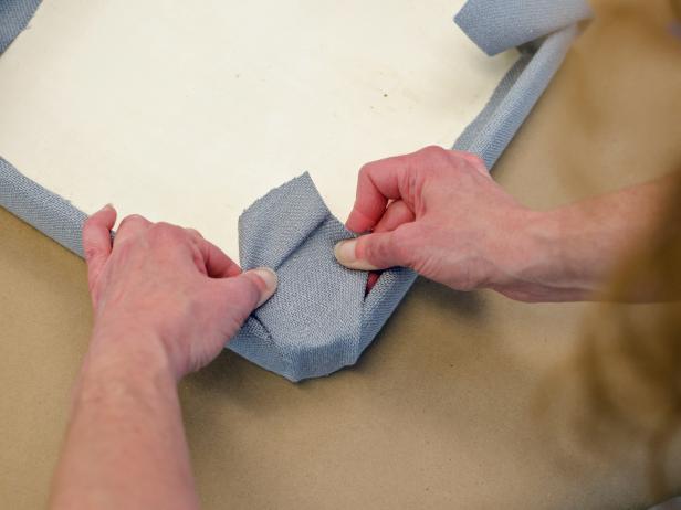 Create tailored corners by pulling the fabric tightly before gluing.