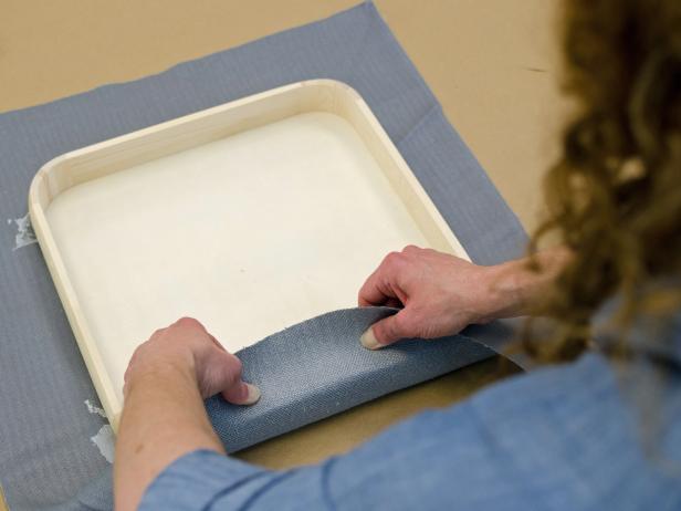 Pull fabric tightly around sides of tray before gluing in place.