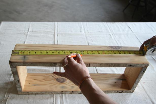 Measure horizontally to find the center of the wood centerpiece.