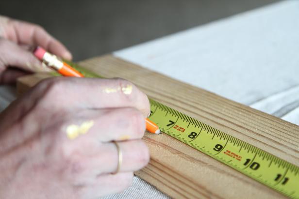 Dan Faires measuring a wood plank at 7 inches