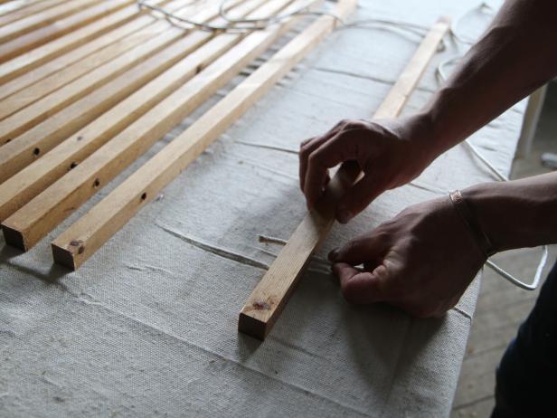 Slide rope through pre-drilled holes in the wood dowel to make a stylish doormat.
