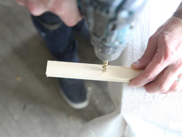 Drill holes in wood dowels to make a stylish doormat.